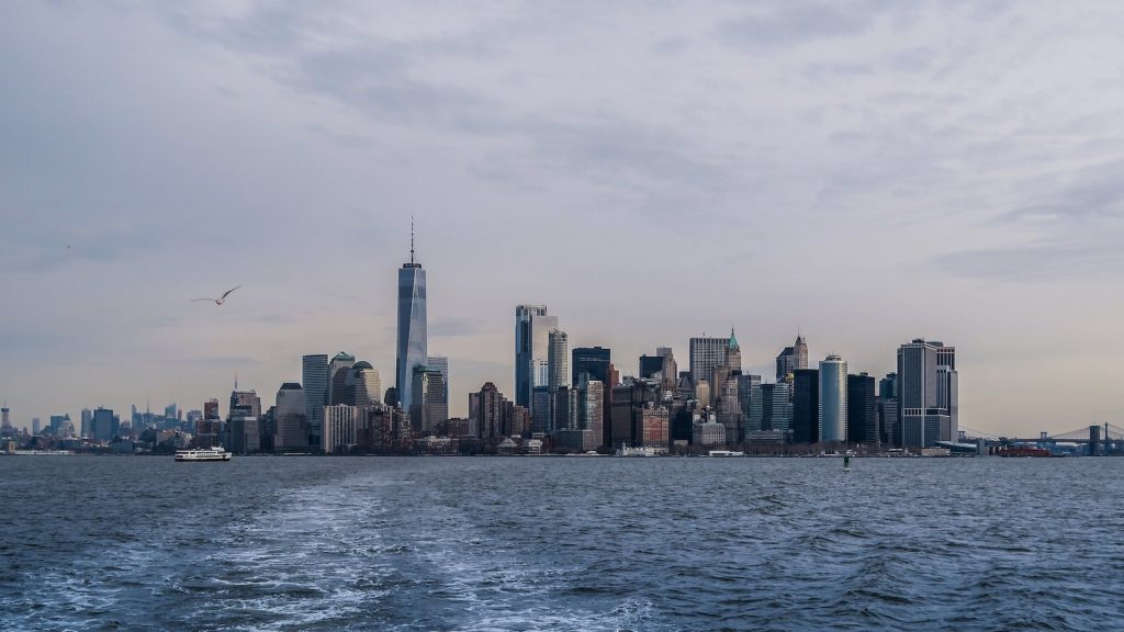 city skyline across body of water during daytime